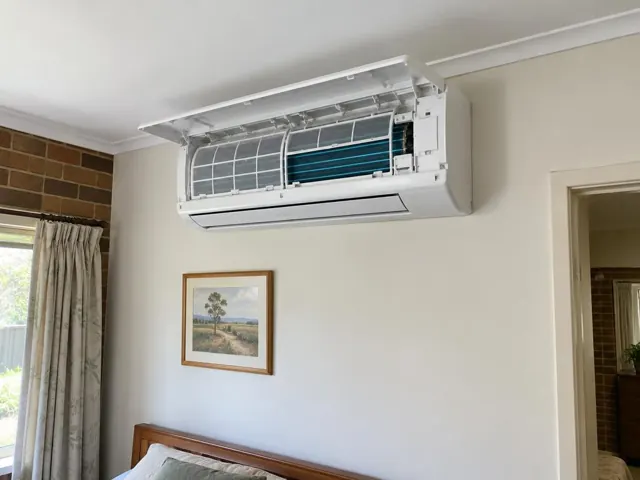 Clean split system indoor head on a cream wall above a framed picture in Ingle Farm